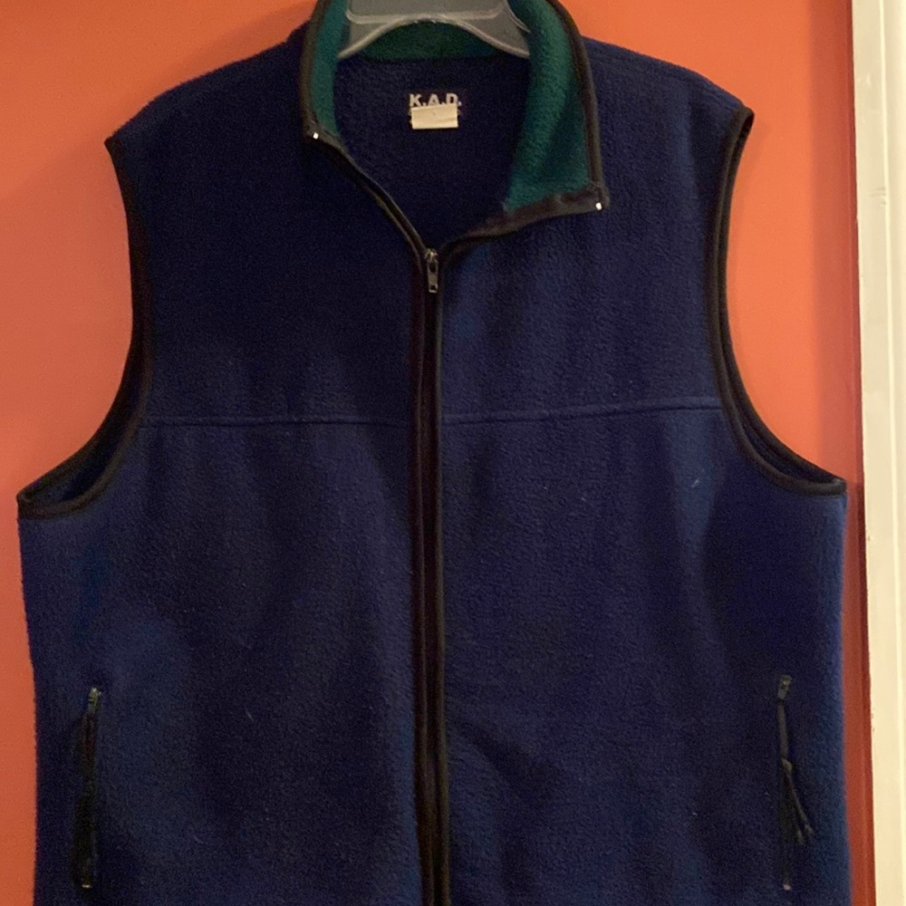 Blue vest jacket with green collar and black trim.